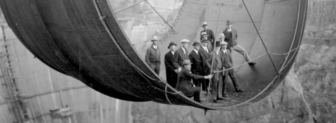 Officials Ride Penstock Pipe During Hoover Dam Construction