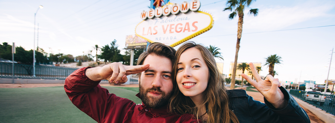 People Having Las Vegas Experience in Front of Welcome Sign