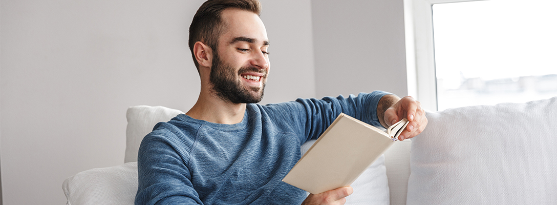 Man Reading Sports Novels at Home