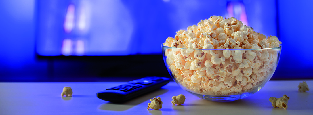 Bowl of Popcorn in Front of TV with Sports Movie