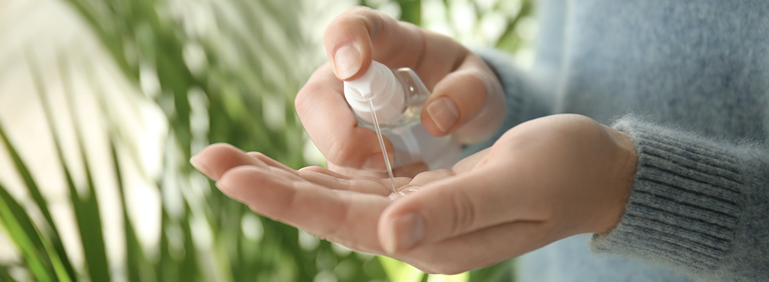 Woman Using Hand Sanitizer While Traveling to Vegas