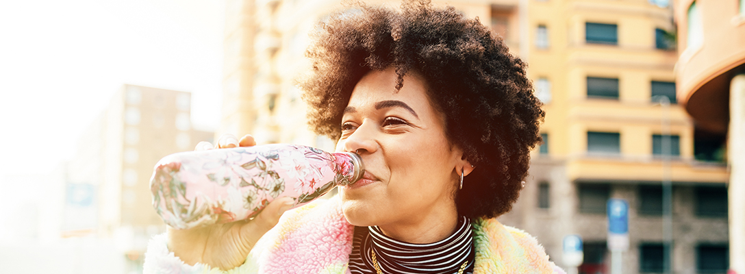 Woman in Las Vegas in Winter Using Reusable Water Bottle