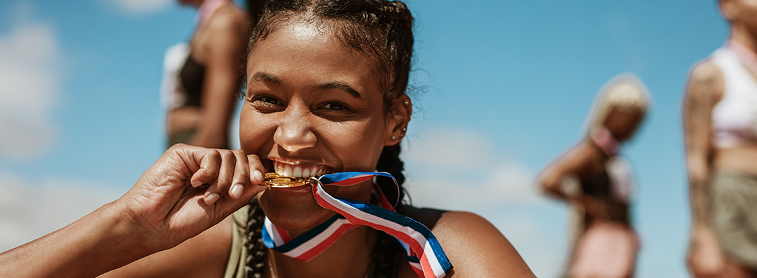 Woman Biting Gold Olympic Medal