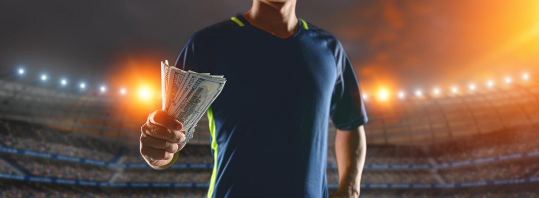 Rich Athlete Holding Stack of Money on Field