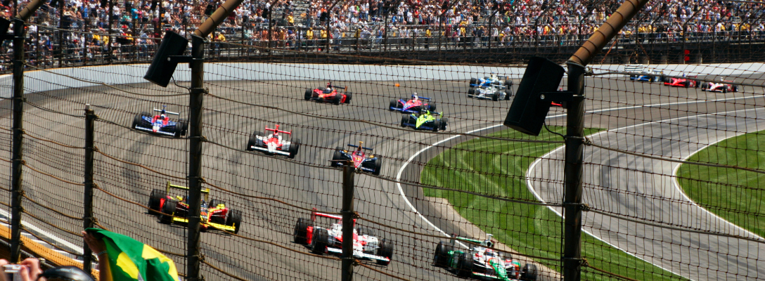 Fans Cheering on Race Car Drivers on Motor Speedway