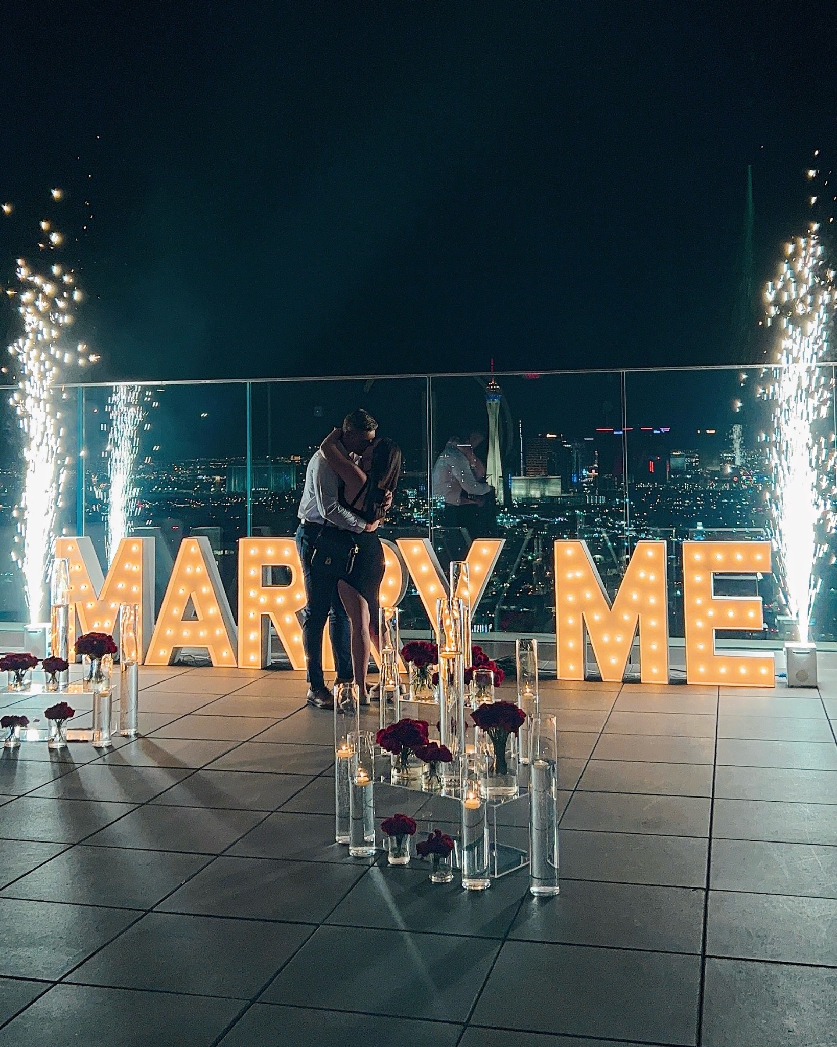 outdoor wedding proposal las vegas strip view rooftop balcony marry me light sign and sparkler foundations