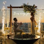 outdoor wedding proposal las vegas strip view rooftop balcony with sparkler fountain and neon it was always you sign at sunset