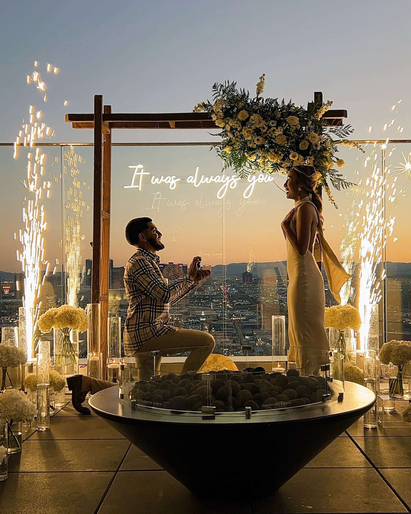 outdoor wedding proposal las vegas strip view rooftop balcony with sparkler fountain and neon it was always you sign at sunset