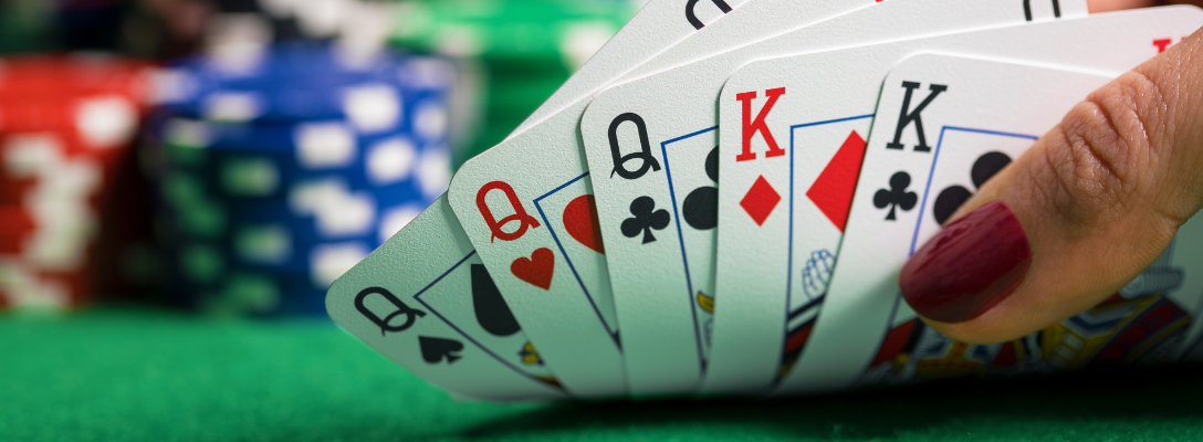 Person Looking at Cards While Playing Poker in Vegas