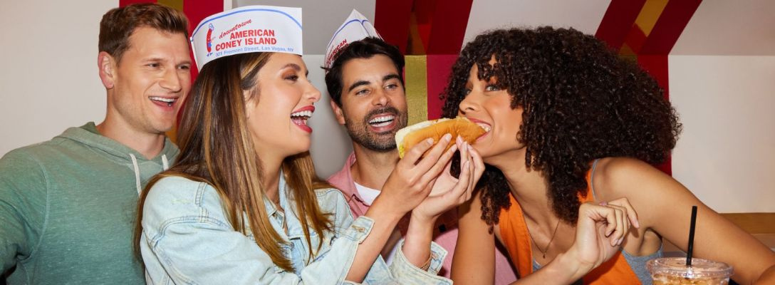 Friends Eating Hot Dogs at American Coney Island in Las Vegas