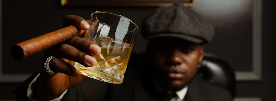 Man Holding Cocktail and Cigar at Las Vegas Cigar Lounge
